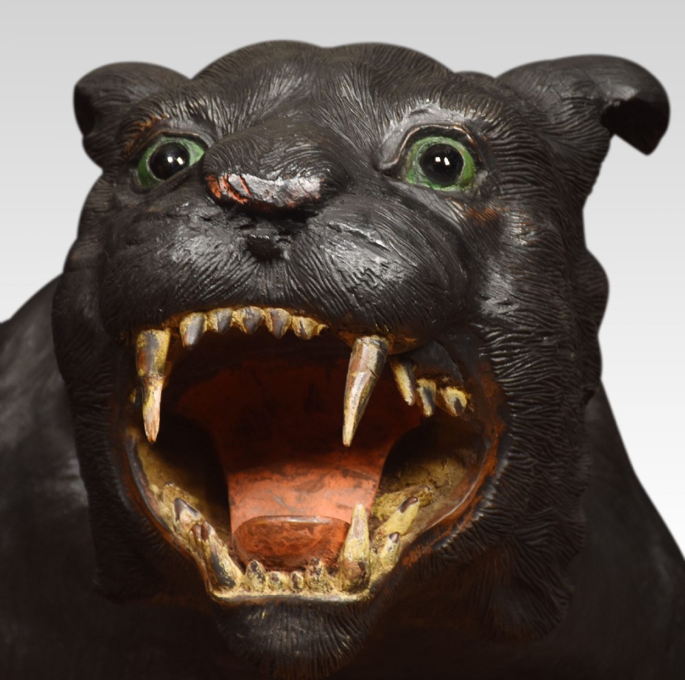 A nineteenth-century hand-carved wooden figure of a snarling black panther with glass eyes and an open painted mouth. View VII