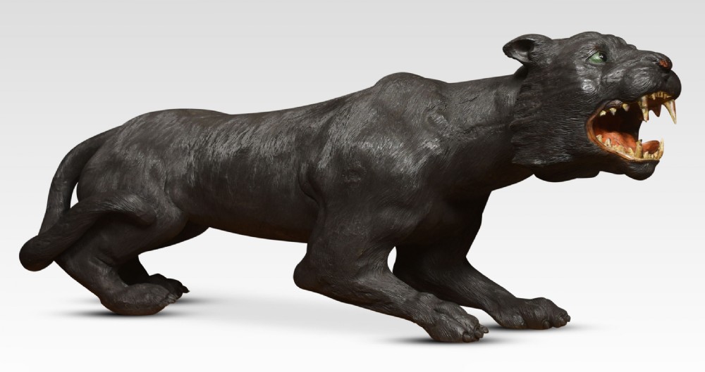 A nineteenth-century hand-carved wooden figure of a snarling black panther with glass eyes and an open painted mouth. View X