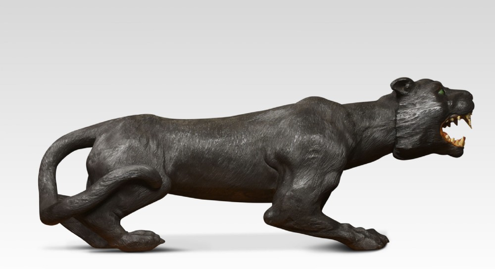 A nineteenth-century hand-carved wooden figure of a snarling black panther with glass eyes and an open painted mouth. View XI
