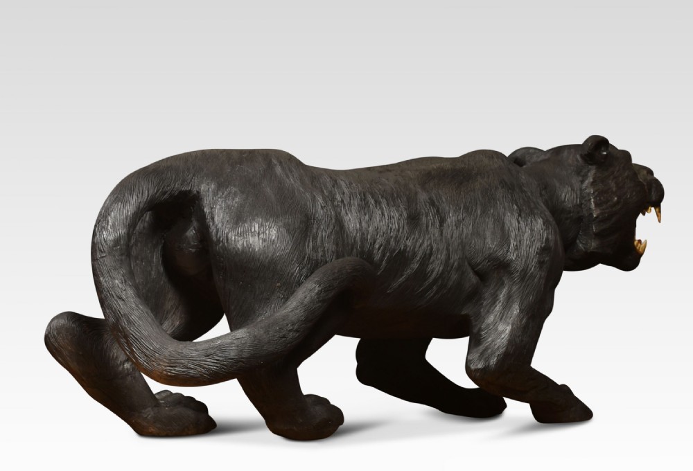 A nineteenth-century hand-carved wooden figure of a snarling black panther with glass eyes and an open painted mouth. View XII
