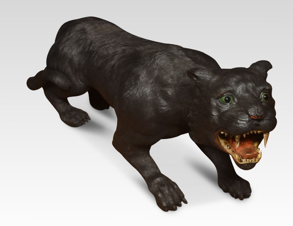 A nineteenth-century hand-carved wooden figure of a snarling black panther with glass eyes and an open painted mouth. View XVI