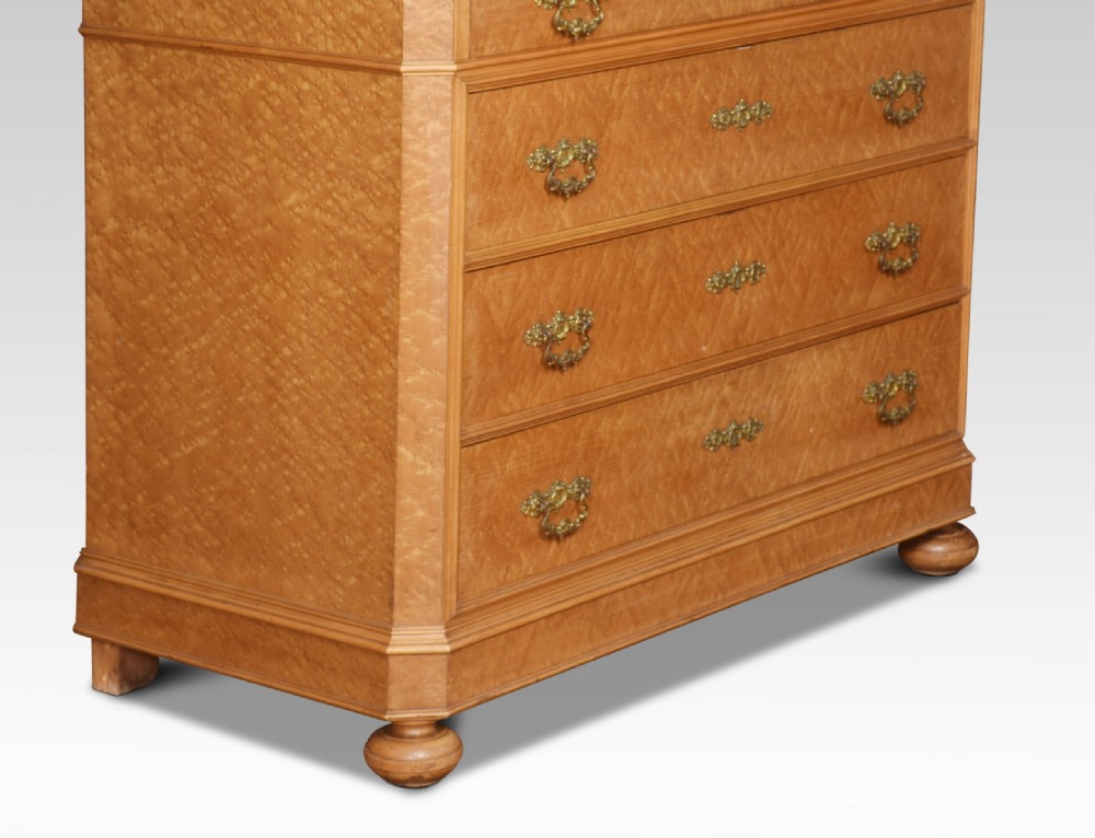 An antique birds eye maple chest of four drawers featuring a marble top, ornate brass handles, and a large arched mirror framed by a carved foliate crest. View V