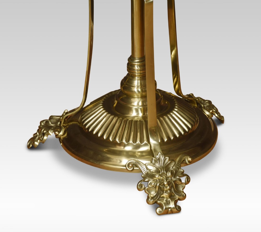 An antique brass standard lamp featuring a central circular onyx tray table, scrolled support brackets, and ornate cast feet. View II