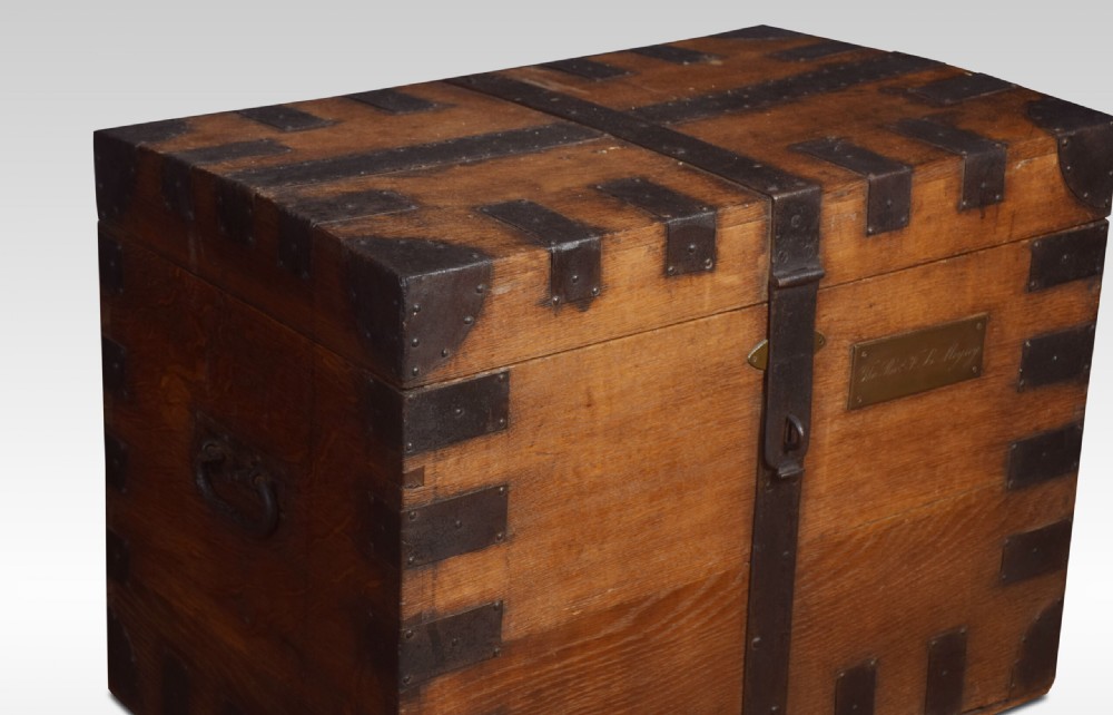 A 19th-century solid oak silver chest reinforced with dark iron straps, corner brackets, and a central latch. View VII