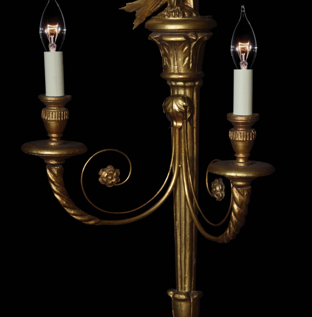 A pair of carved giltwood two-branch wall lights featuring top ribbon bows, carved birds, and fluted central shafts. View III