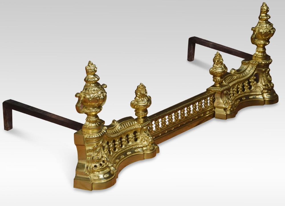 A 19th-century French adjustable gilt-brass fireplace fender featuring twin urn finials and pierced scrollwork. View II