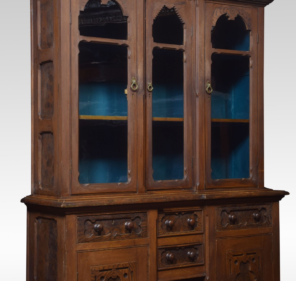 A tall Victorian pine kitchen dresser featuring a faux-grained brown scumbled finish, three glazed upper doors with gothic arched tracery, a blue painted interior, and a lower cupboard base. View VIII