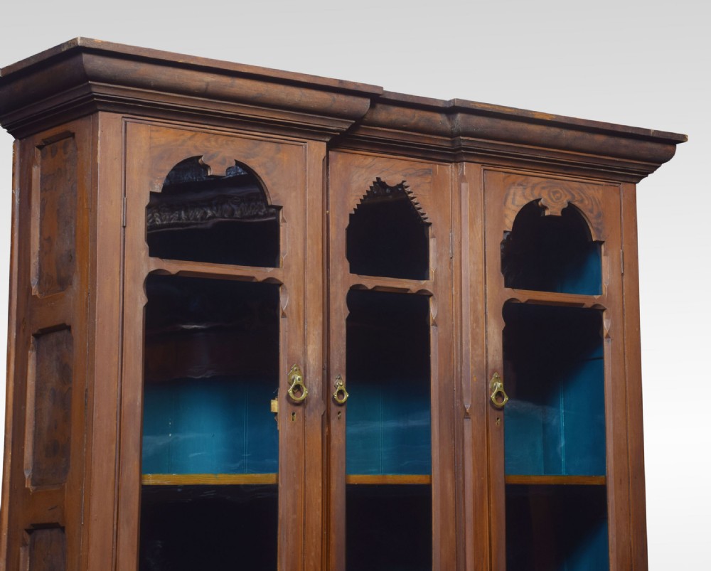 A tall Victorian pine kitchen dresser featuring a faux-grained brown scumbled finish, three glazed upper doors with gothic arched tracery, a blue painted interior, and a lower cupboard base. View IX