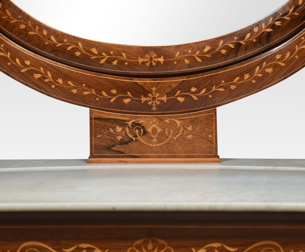 An antique 19th-century rosewood dressing table featuring floral marquetry inlay, a white marble top, and an oval swivel mirror flanked by swan-neck supports. View VII