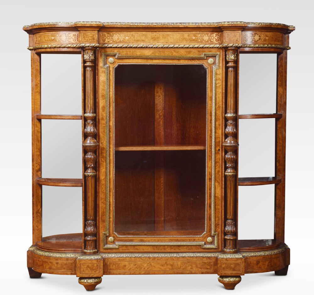 A nineteenth-century figured walnut credenza with a glazed central door, open mirrored side shelves, floral marquetry inlay, and gilt-bronze mounts.