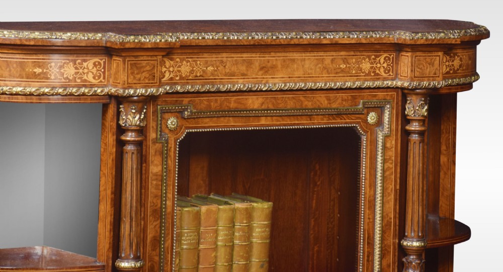 A nineteenth-century figured walnut credenza with a glazed central door, open mirrored side shelves, floral marquetry inlay, and gilt-bronze mounts. View XI
