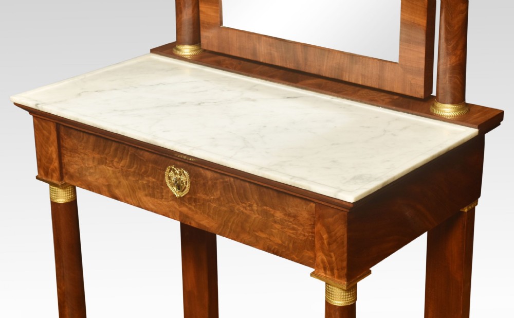 A French Empire mahogany dressing table with a white marble top, pivoting arched mirror flanked by columns, and gilt-bronze mounts. View V