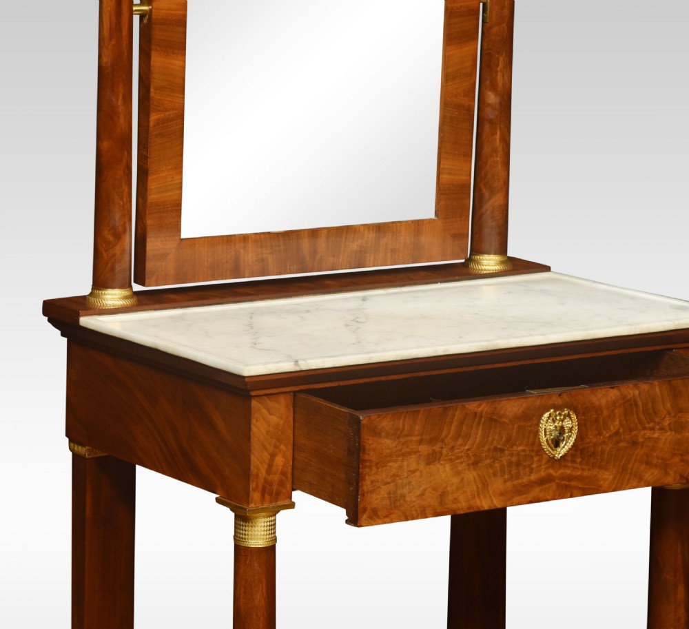 A French Empire mahogany dressing table with a white marble top, pivoting arched mirror flanked by columns, and gilt-bronze mounts. View IX