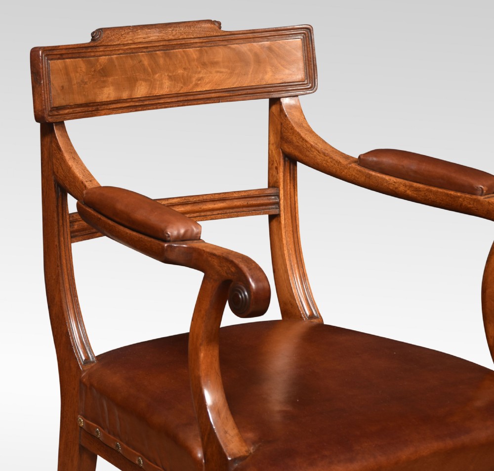 A set of eight Regency mahogany dining chairs featuring brown leather seats with brass stud detail, tablet top rails, and sabre legs. View II