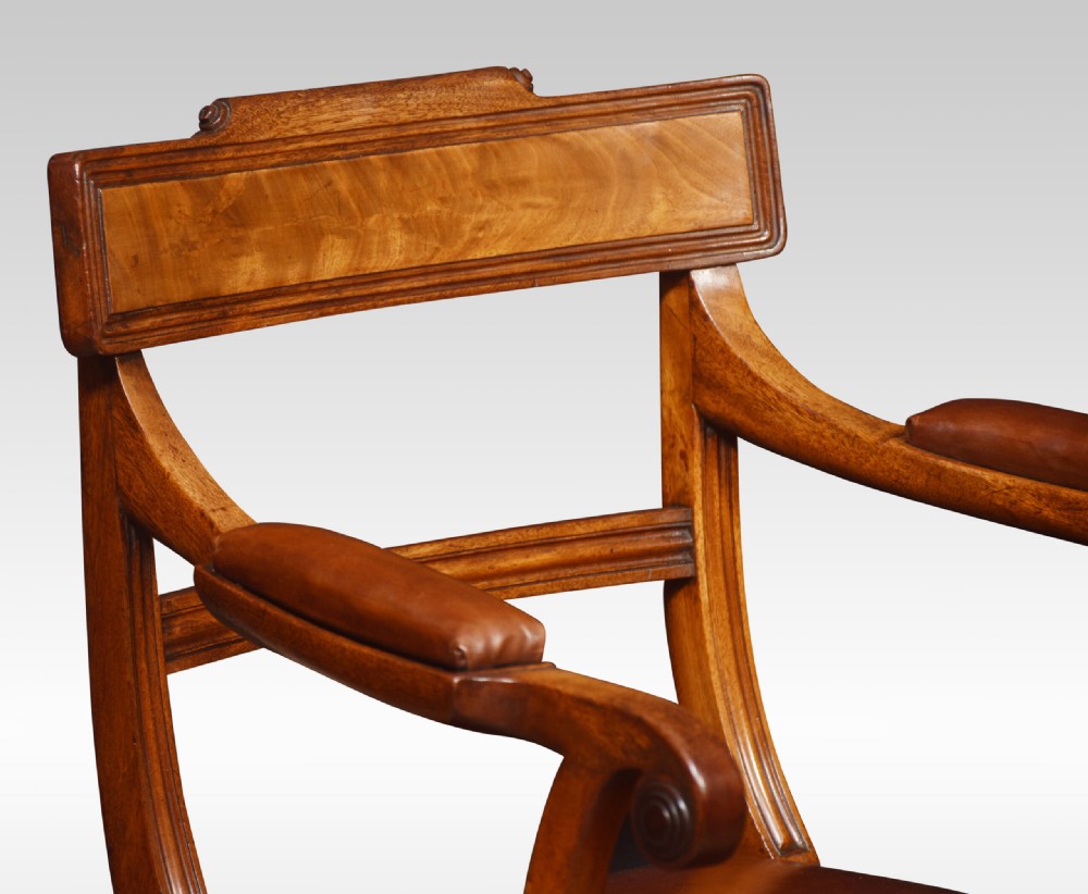 A set of eight Regency mahogany dining chairs featuring brown leather seats with brass stud detail, tablet top rails, and sabre legs. View IV