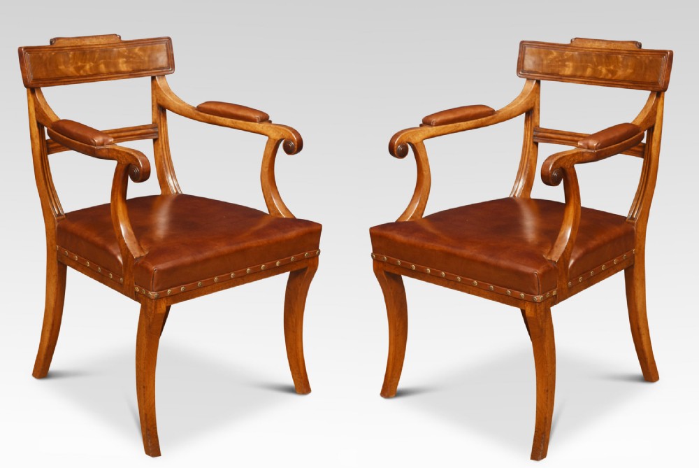 A set of eight Regency mahogany dining chairs featuring brown leather seats with brass stud detail, tablet top rails, and sabre legs. View VI