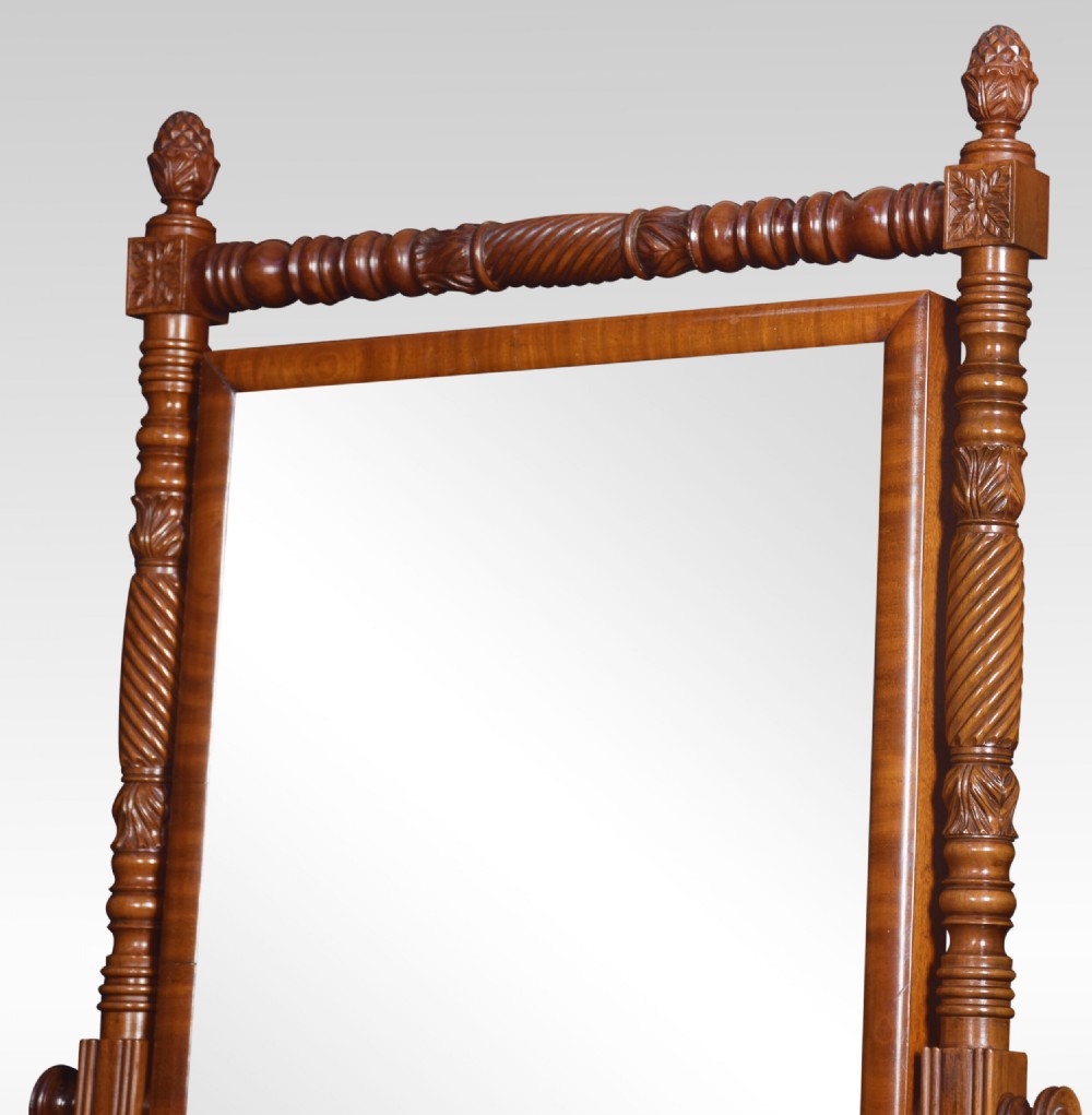 A Regency period mahogany cheval mirror featuring spiral-turned upright columns, finials, and a rectangular tilting frame resting on splayed legs with brass lion paw castors. View VIII