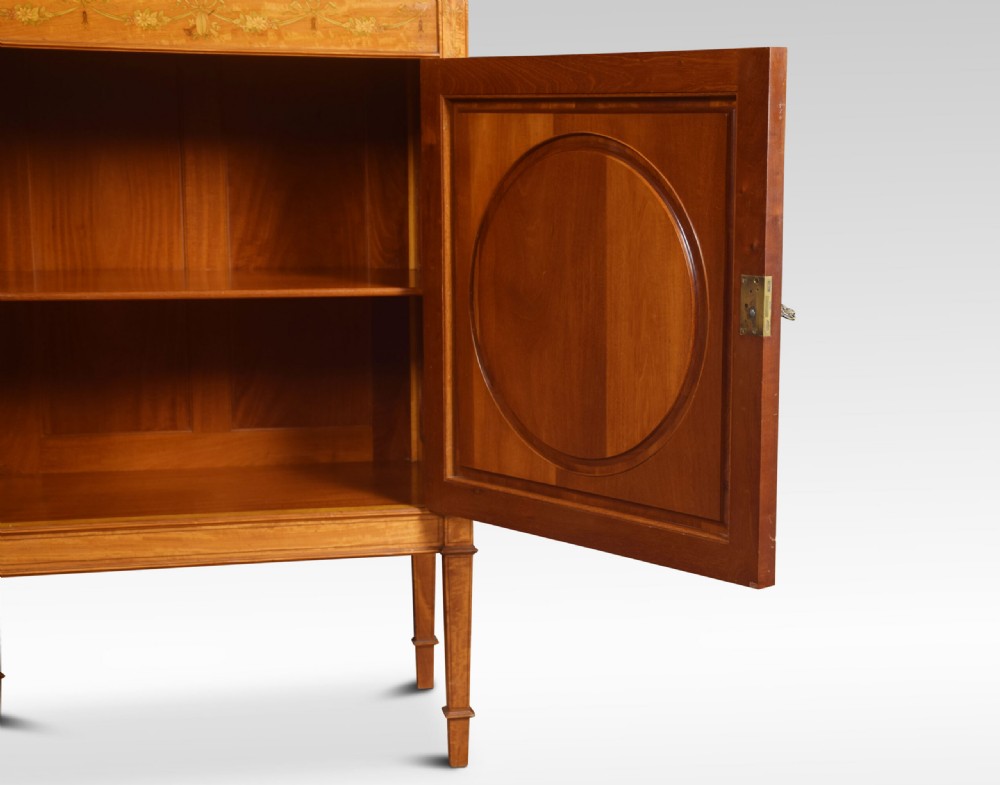 A late 19th-century satinwood side cabinet featuring intricate floral marquetry inlay, a central circular wreath medallion on a single panelled door, and square tapered legs. View III