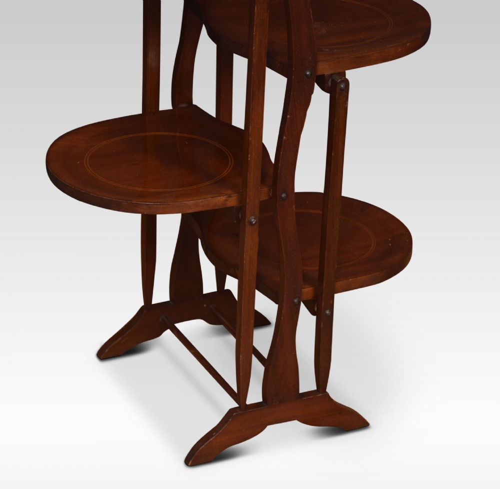 An antique four-tiered mahogany folding cake stand with circular inlaid trays and a turned top handle. View IV