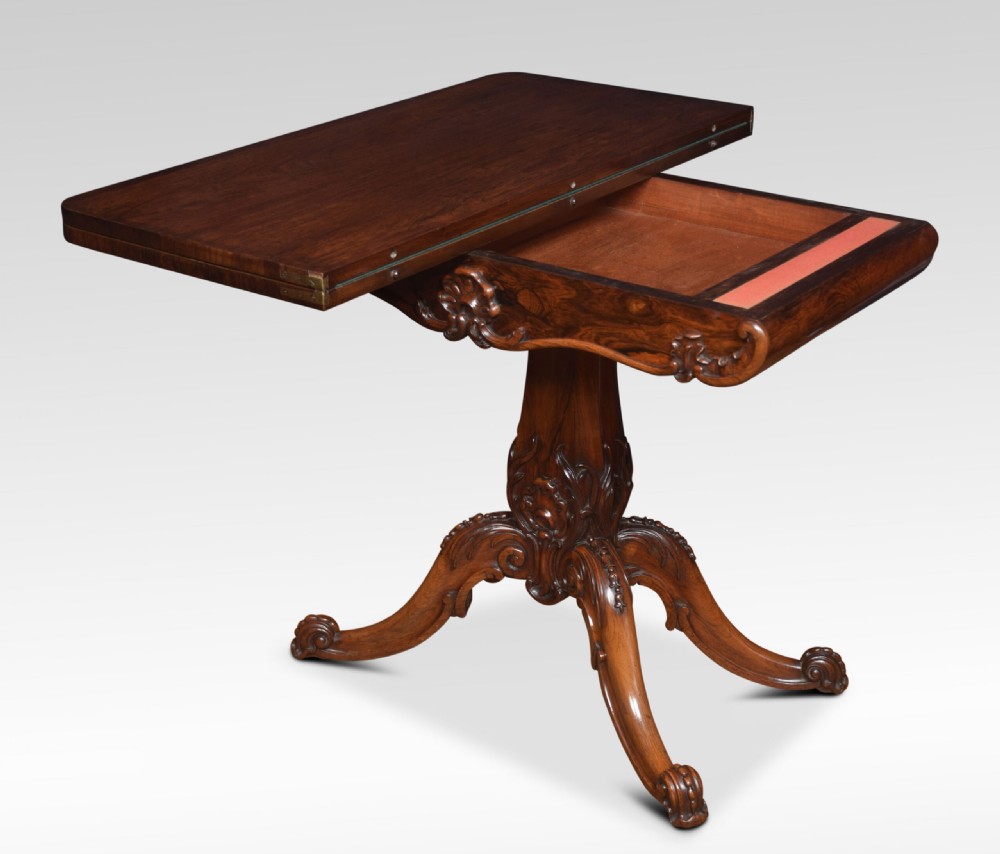 A Victorian dark rosewood fold-over card table featuring an ornate carved frieze, a central carved pedestal column, and carved scroll legs. View V