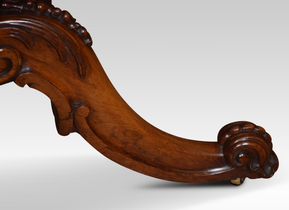 A Victorian dark rosewood fold-over card table featuring an ornate carved frieze, a central carved pedestal column, and carved scroll legs. View XI