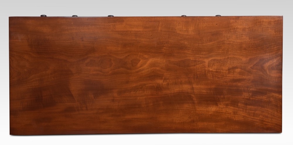 A Regency period warm brown mahogany sideboard featuring four cupboard doors, three top drawers, turned wooden knobs, and an arched central alcove. View XII