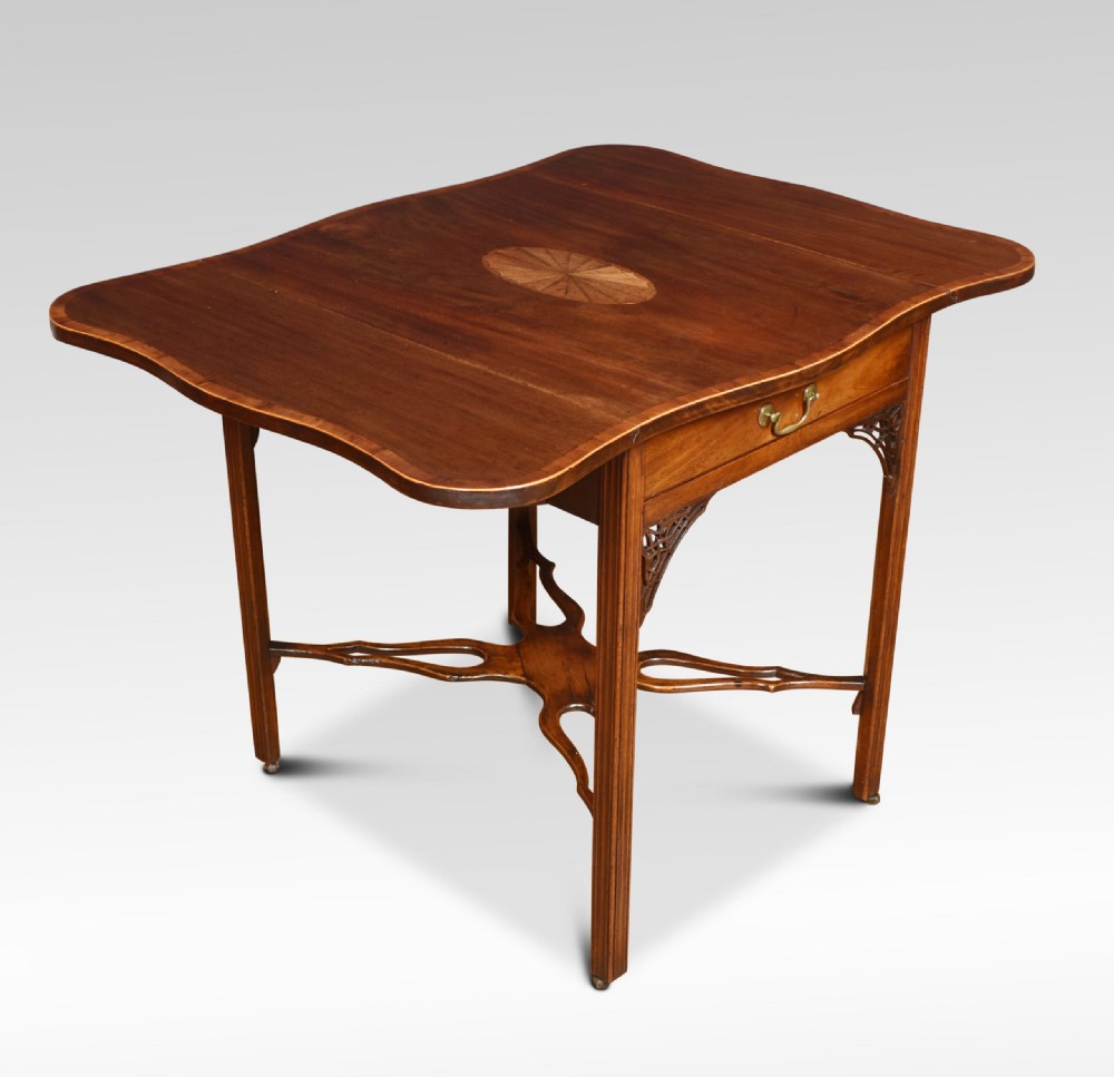 A George III mahogany Pembroke table with drop leaves, an oval satinwood inlay on top, a single drawer with a brass handle, and an X-shaped stretcher base. View II