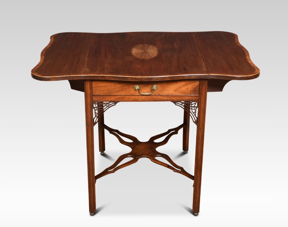 A George III mahogany Pembroke table with drop leaves, an oval satinwood inlay on top, a single drawer with a brass handle, and an X-shaped stretcher base. View V