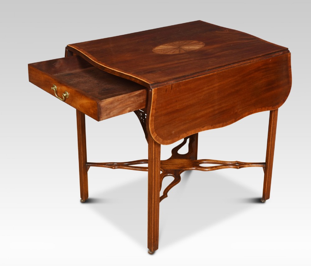 A George III mahogany Pembroke table with drop leaves, an oval satinwood inlay on top, a single drawer with a brass handle, and an X-shaped stretcher base. View VII