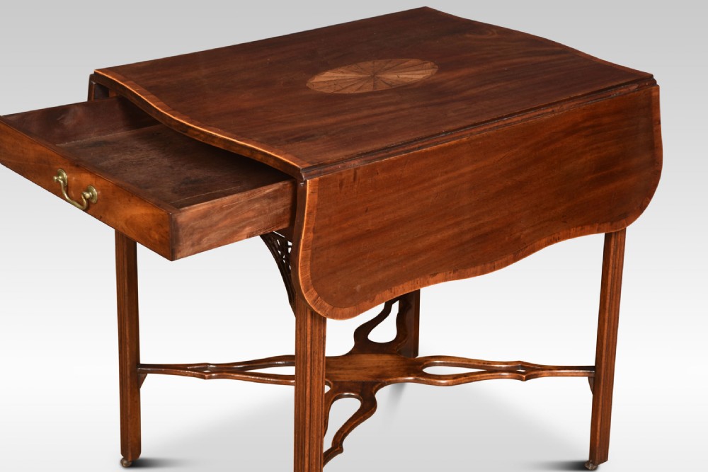 A George III mahogany Pembroke table with drop leaves, an oval satinwood inlay on top, a single drawer with a brass handle, and an X-shaped stretcher base. View VIII