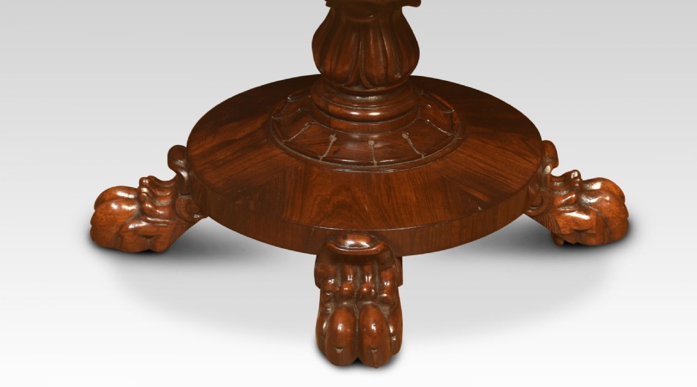An antique rosewood sewing table featuring a drop-leaf top, a single drawer above a pleated cream fabric basket, and a turned central column on carved paw feet. View II