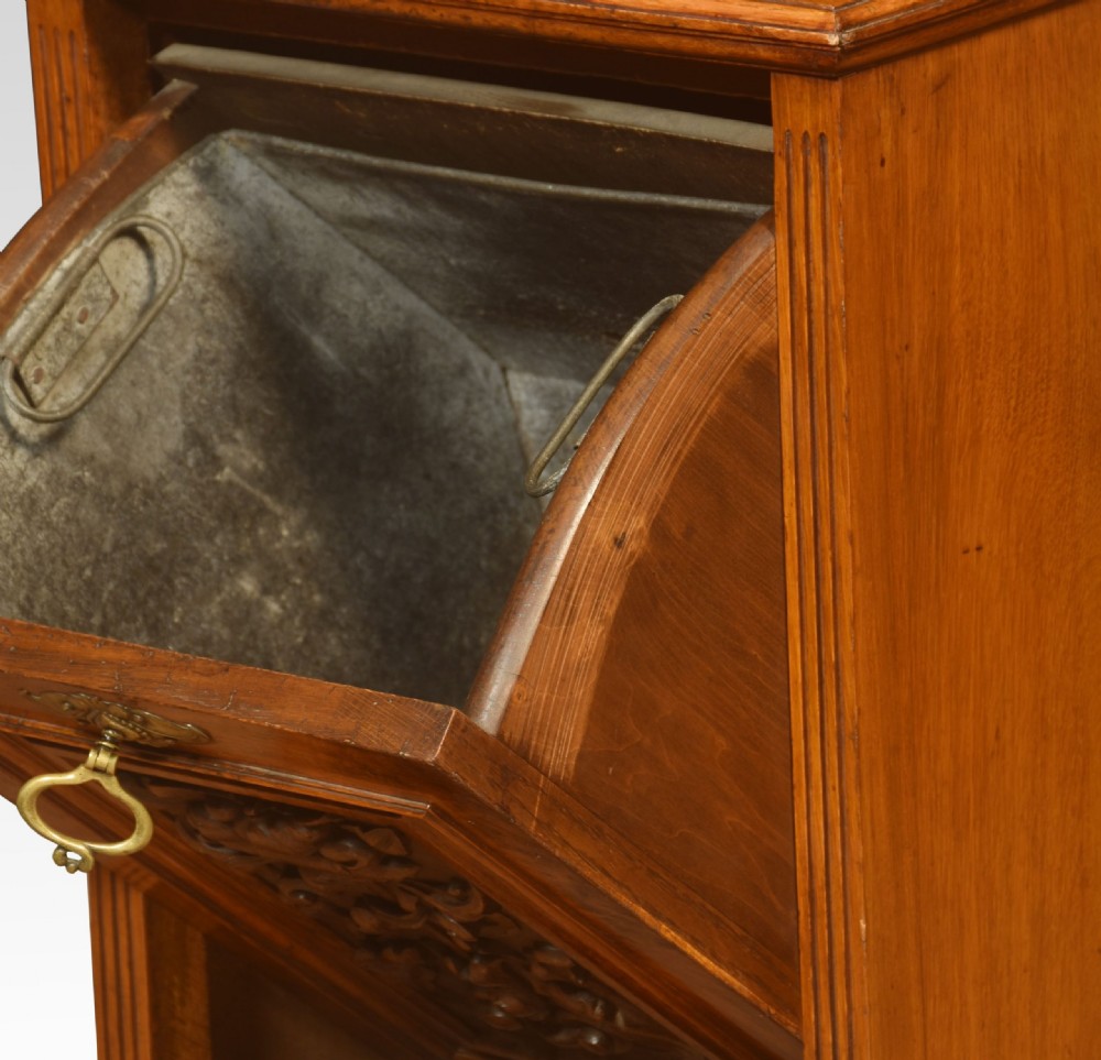 A Victorian pollard oak fireside purdonium featuring a carved floral panel, brass drop handle, turned columns, and a mirrored upper shelf with a brass gallery rail. View IV