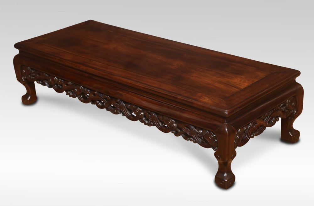 A pair of rectangular low Chinese hardwood coffee tables featuring detailed openwork carved aprons and short cabriole legs. View VI