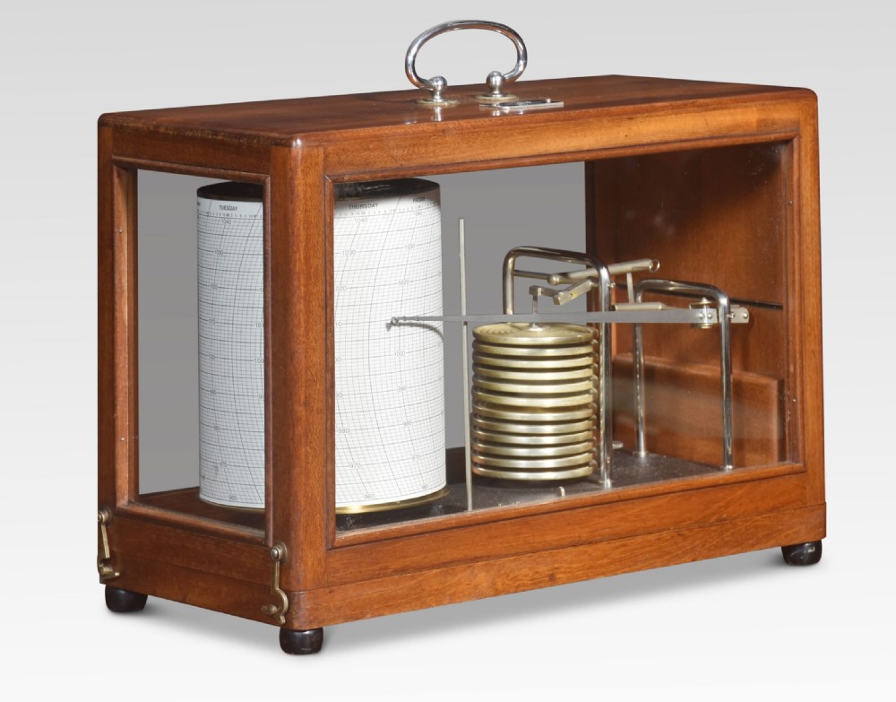An antique mahogany barograph with glass panels displaying an internal brass mechanism, aneroid capsules, and a paper chart drum.