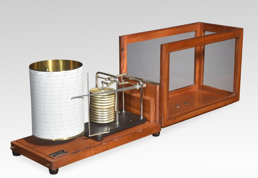 An antique mahogany barograph with glass panels displaying an internal brass mechanism, aneroid capsules, and a paper chart drum. View IV