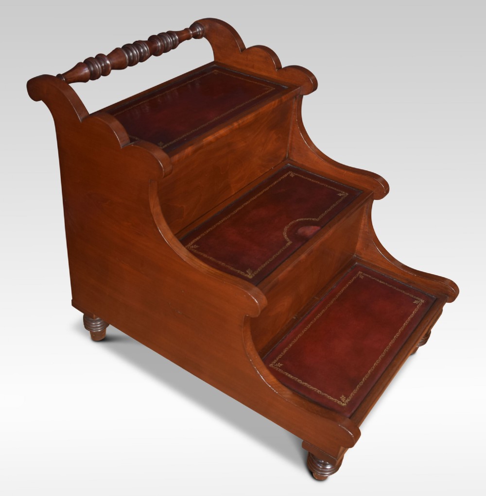 A 19th-century mahogany library step stool featuring three treads inlaid with gold-tooled leather and a top turned wooden handle. View IV
