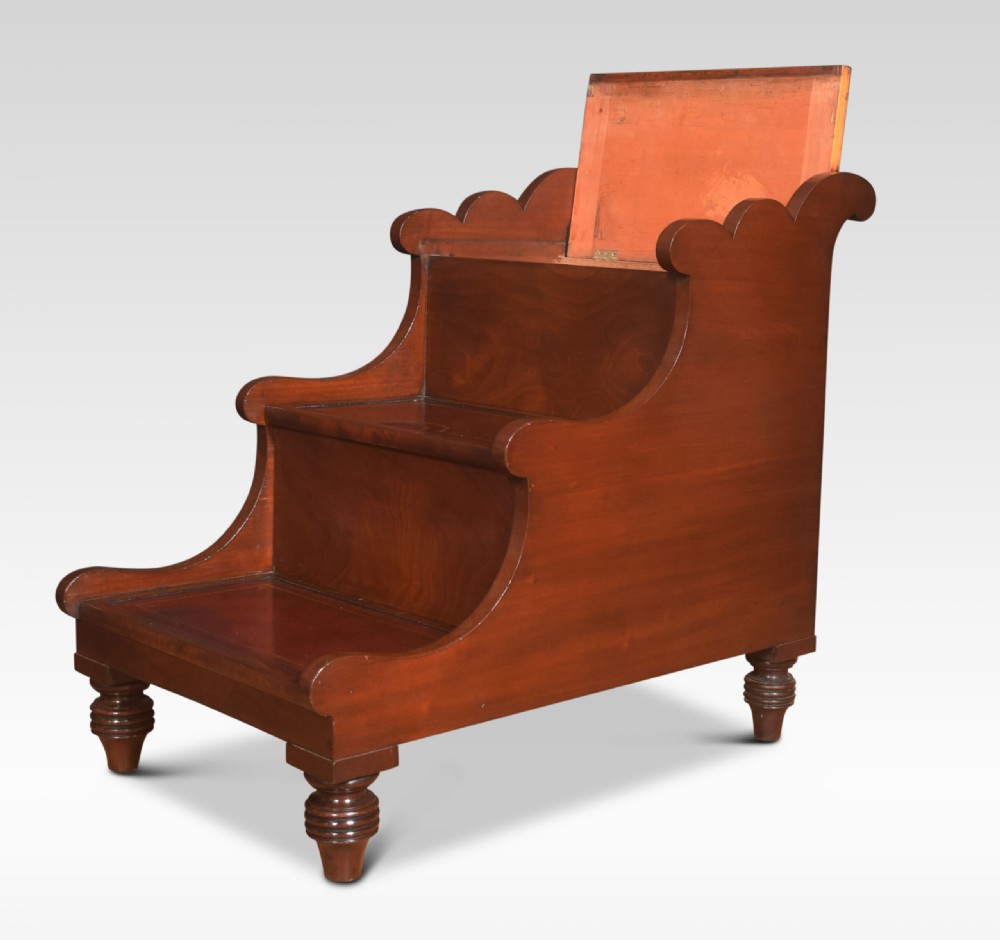 A 19th-century mahogany library step stool featuring three treads inlaid with gold-tooled leather and a top turned wooden handle. View VI