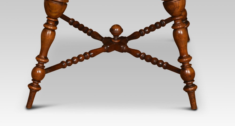 A late nineteenth-century walnut two-tier occasional table featuring turned legs, a spindle gallery on the lower shelf, and a moulded square top. View VI