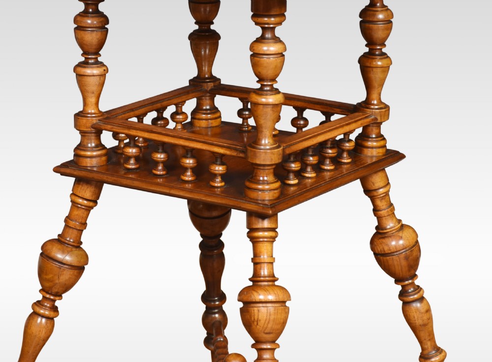 A late nineteenth-century walnut two-tier occasional table featuring turned legs, a spindle gallery on the lower shelf, and a moulded square top. View VII