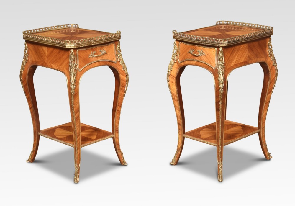 A pair of French Louis XV style walnut bedside tables featuring slender cabriole legs, brass mounts, single drawer handles, lower shelves, and pierced brass galleries around the tops. View II
