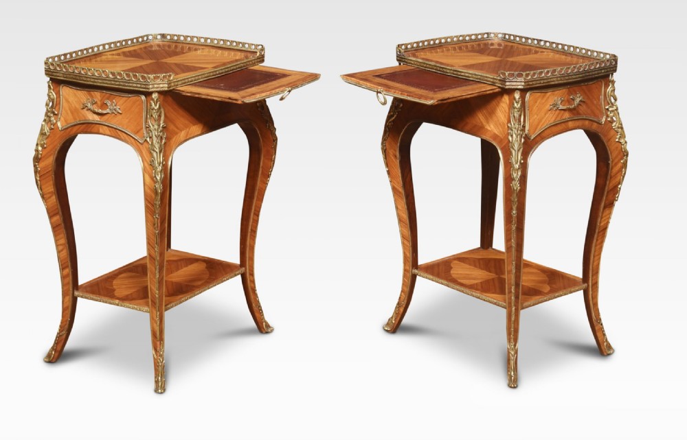 A pair of French Louis XV style walnut bedside tables featuring slender cabriole legs, brass mounts, single drawer handles, lower shelves, and pierced brass galleries around the tops. View VII