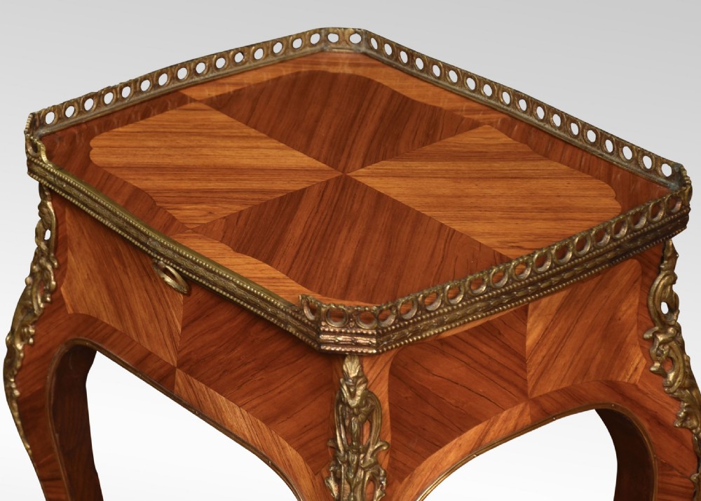 A pair of French Louis XV style walnut bedside tables featuring slender cabriole legs, brass mounts, single drawer handles, lower shelves, and pierced brass galleries around the tops. View X