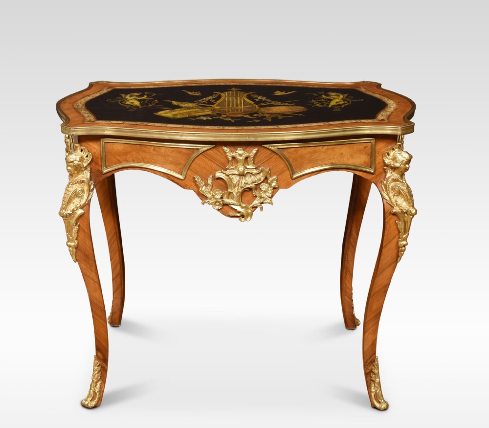 A French Louis XV style walnut centre table featuring cabriole legs, ornate gilt bronze mounts, and an ebonised top decorated with musical instrument marquetry. View VII