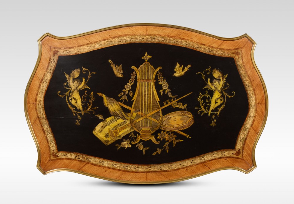 A French Louis XV style walnut centre table featuring cabriole legs, ornate gilt bronze mounts, and an ebonised top decorated with musical instrument marquetry. View X