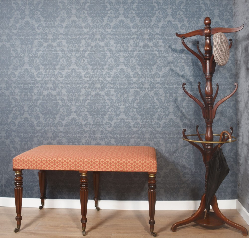 A tall Victorian mahogany coat and umbrella stand featuring a turned central column, multi-tiered curved hooks, a brass umbrella ring, and a four-legged base. View II