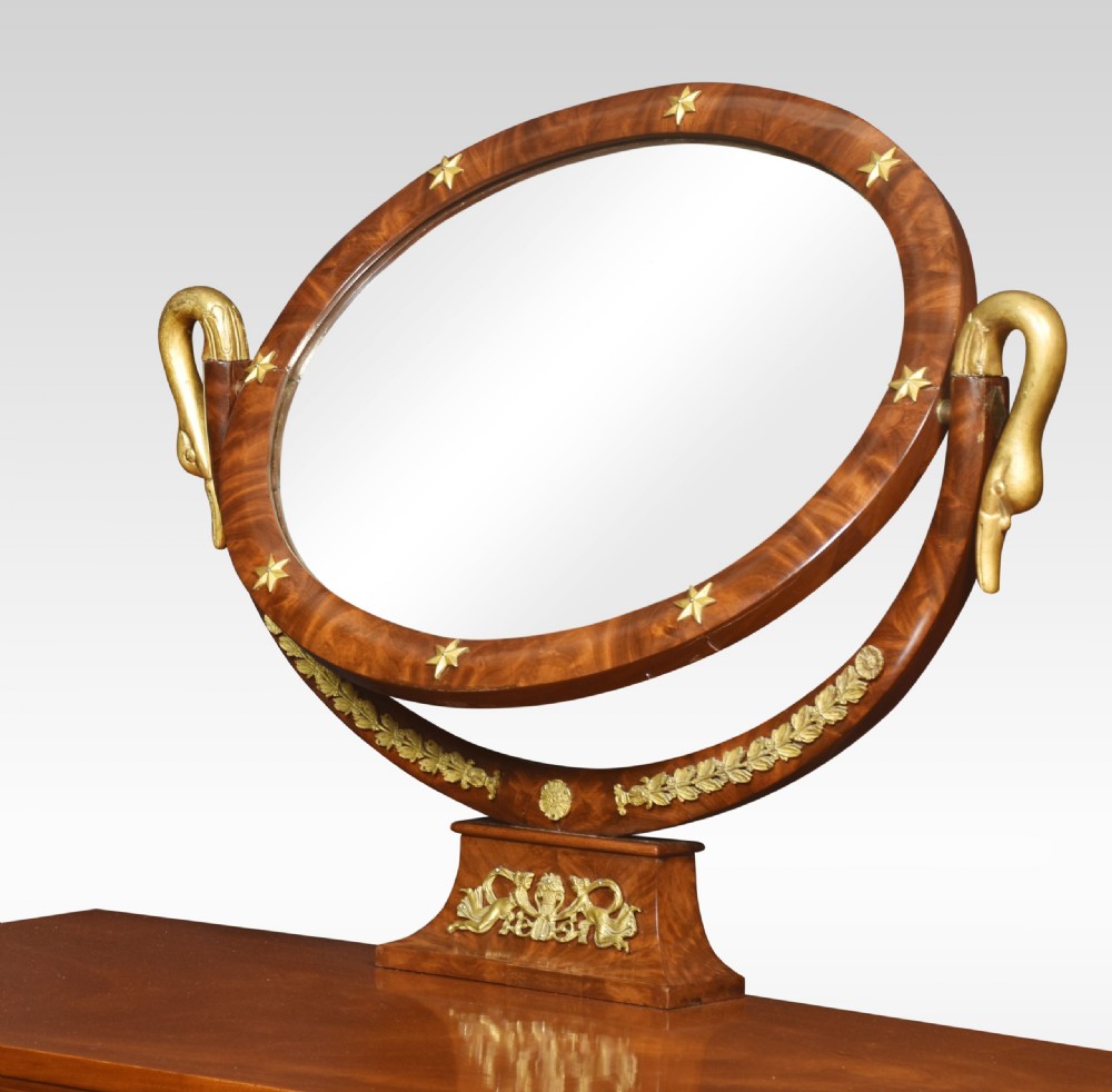 A 19th-century French Empire mahogany dressing table with an oval swivelling mirror, gilded bronze ormolu mounts, swan neck supports, and lion head handles. View VII