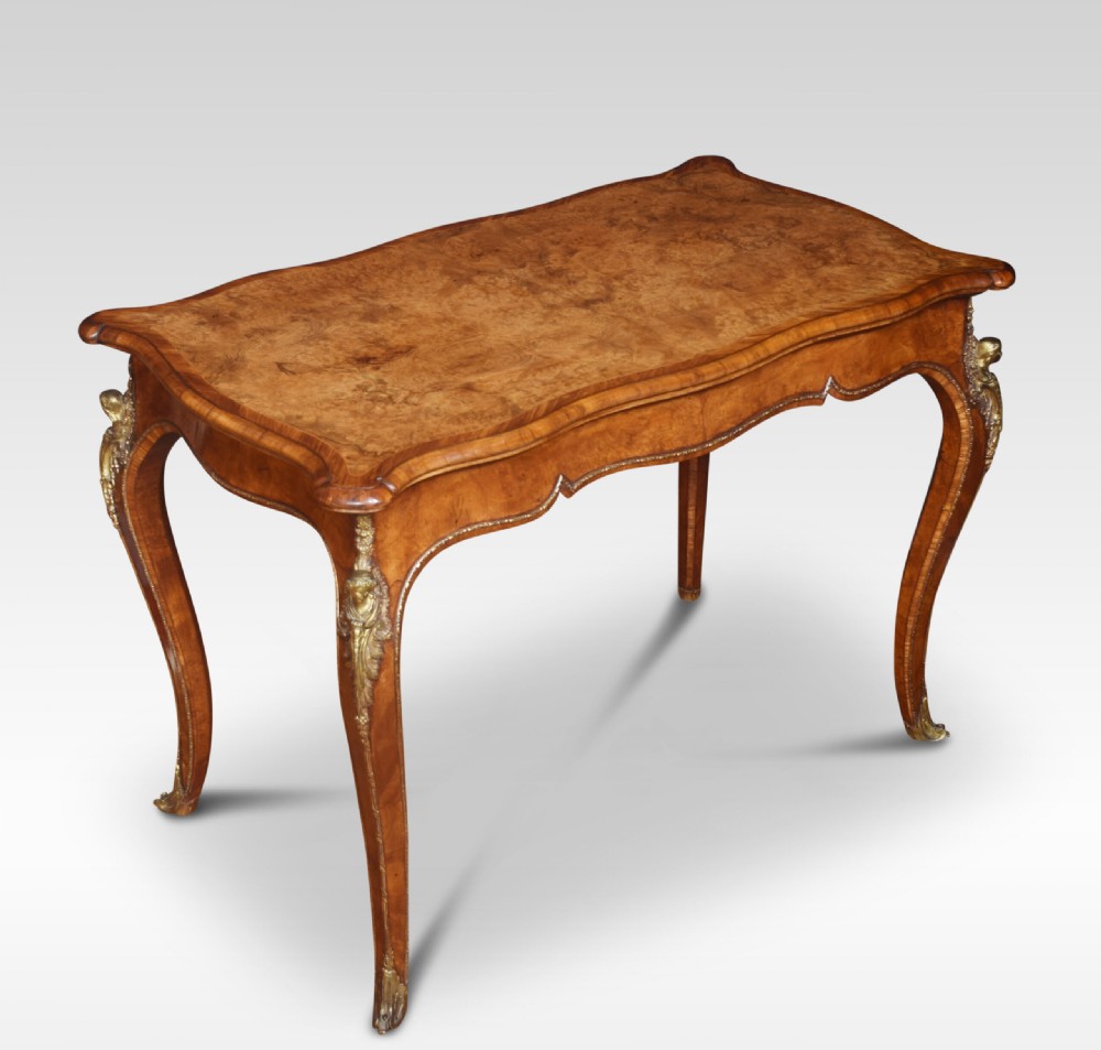 A nineteenth-century burr walnut card table featuring a serpentine top, carved frieze, cabriole legs, and ornate gilt bronze ormolu mounts. View VII