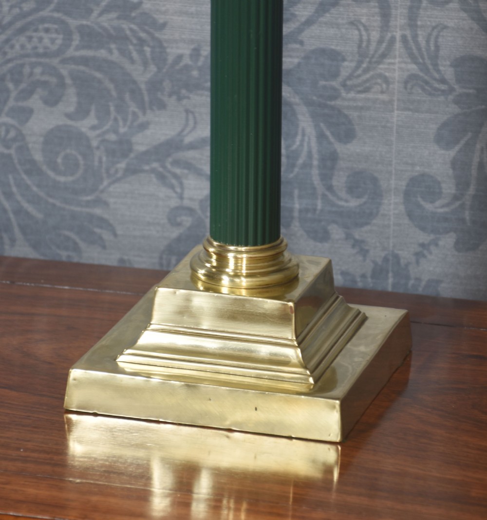 A Neoclassical table lamp featuring a green fluted column, a cast brass Corinthian capital, a stepped square base, and a pleated grey fabric shade. View V