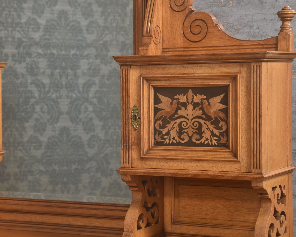 An oak dressing table featuring marquetry inlay patterns on the drawers and side cabinets, a central rectangular mirror, turned legs, and an H-stretcher. View III