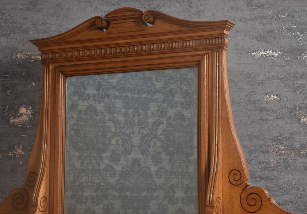 An oak dressing table featuring marquetry inlay patterns on the drawers and side cabinets, a central rectangular mirror, turned legs, and an H-stretcher. View VI